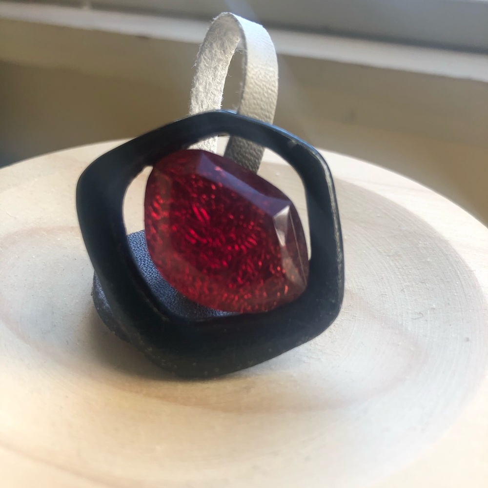 Black ring with pink rock.